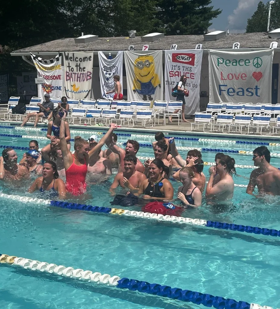 Swim team celebrating in the pool