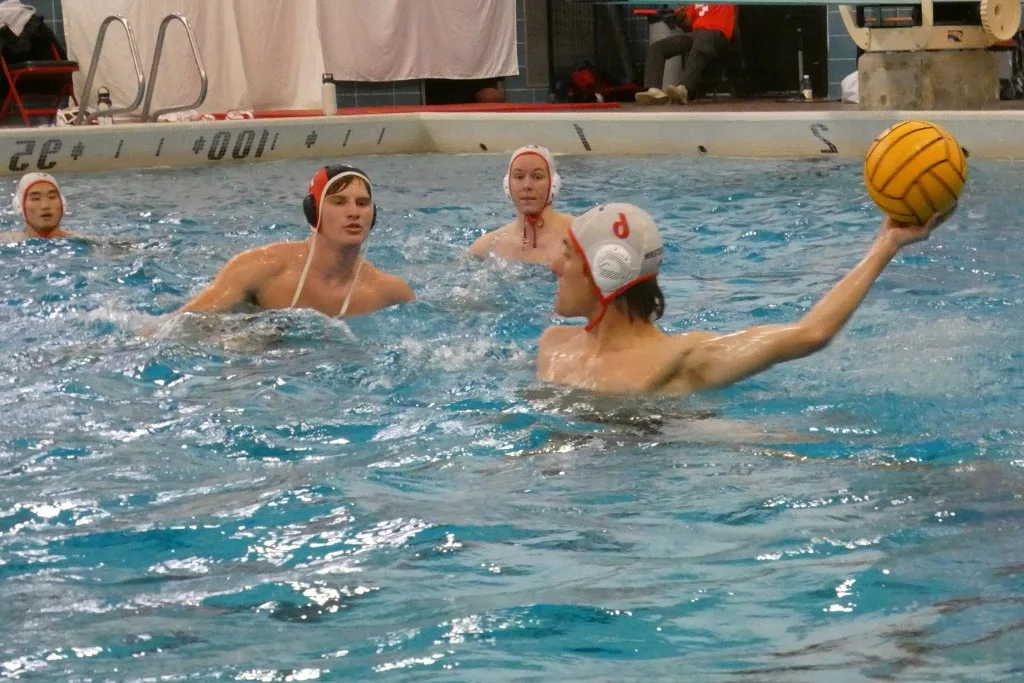 Rowan Frew throwing a water polo ball during a game